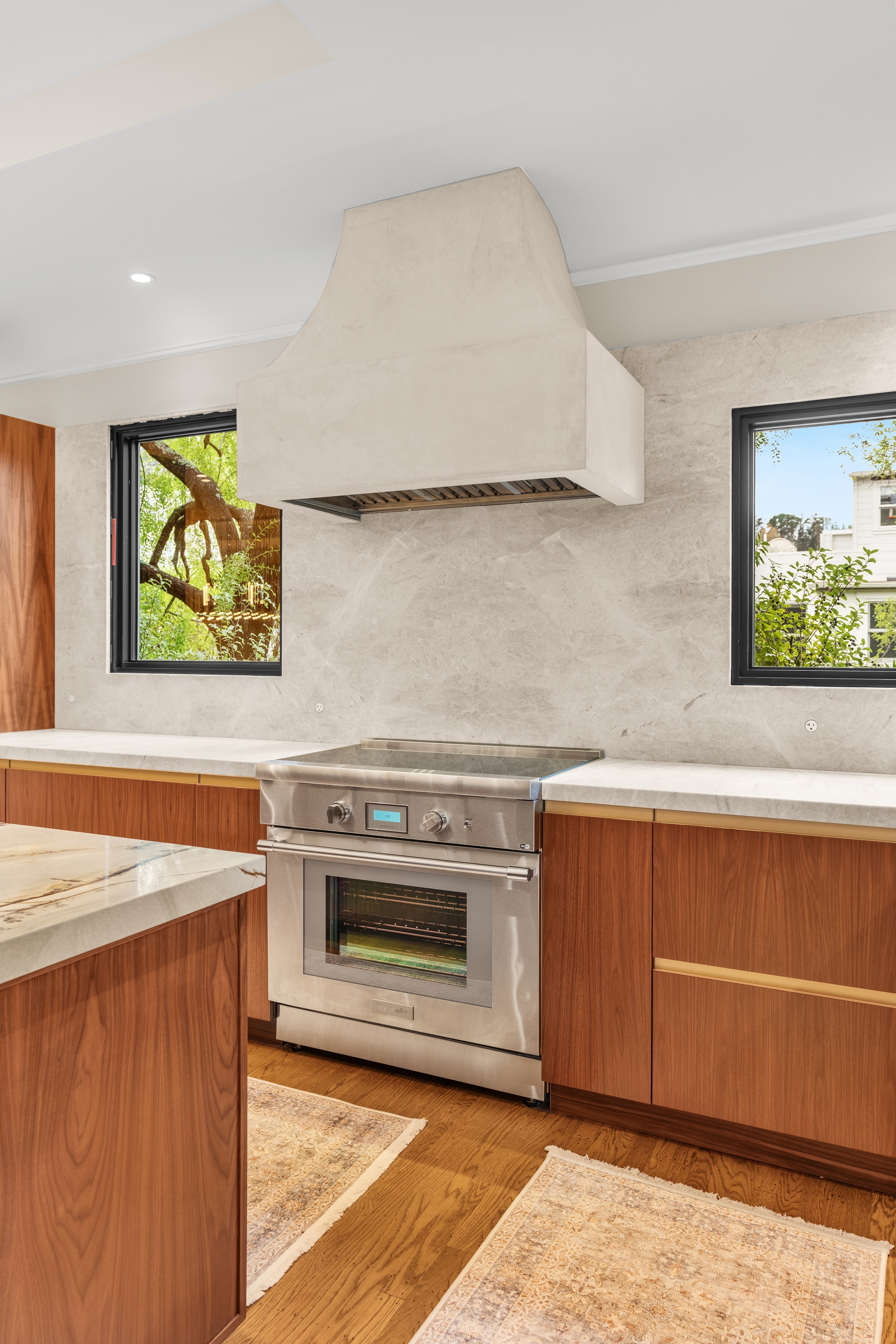 Kitchen with wood cabinetry and open refrigerator