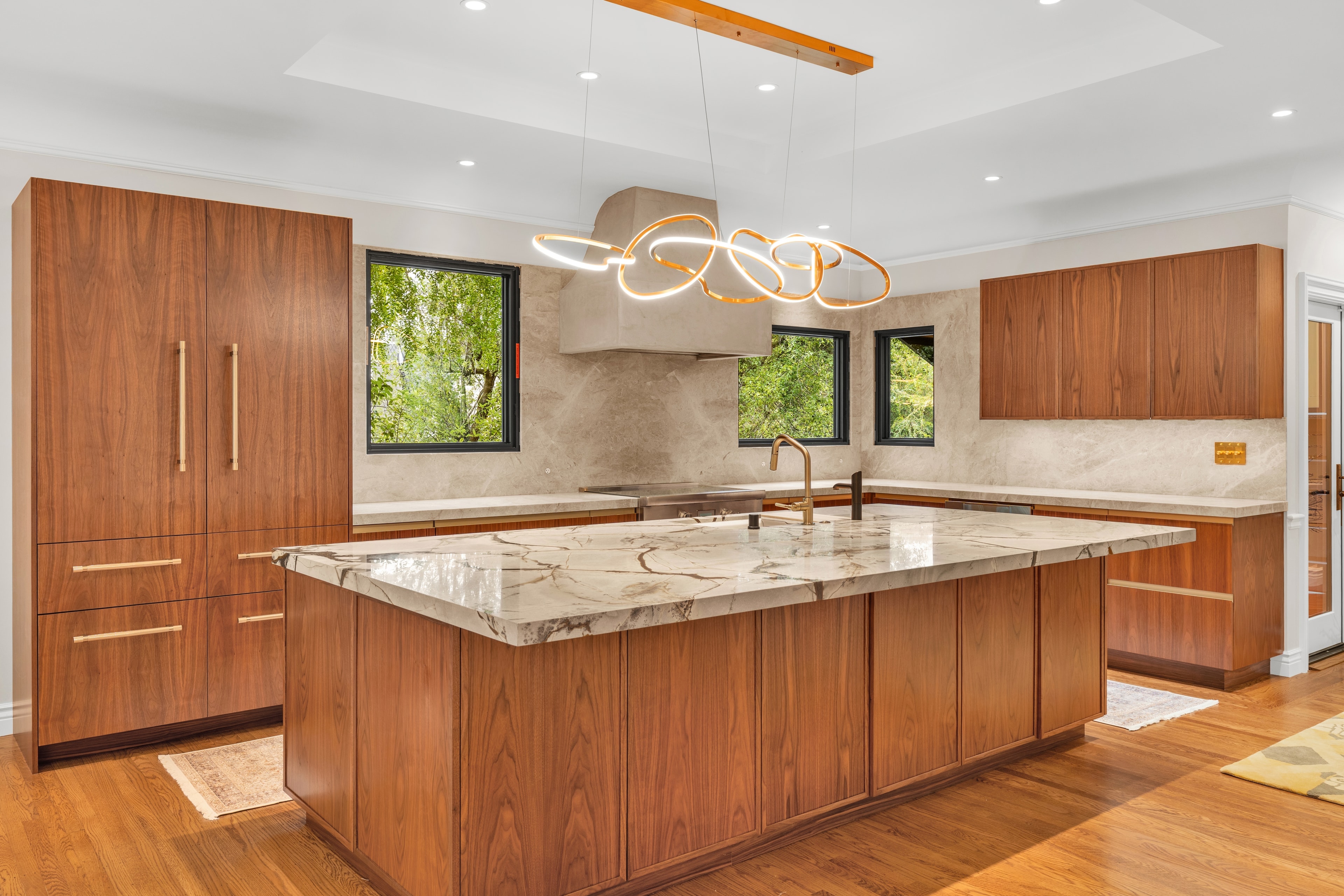 Bright kitchen with island and gold pendant lights