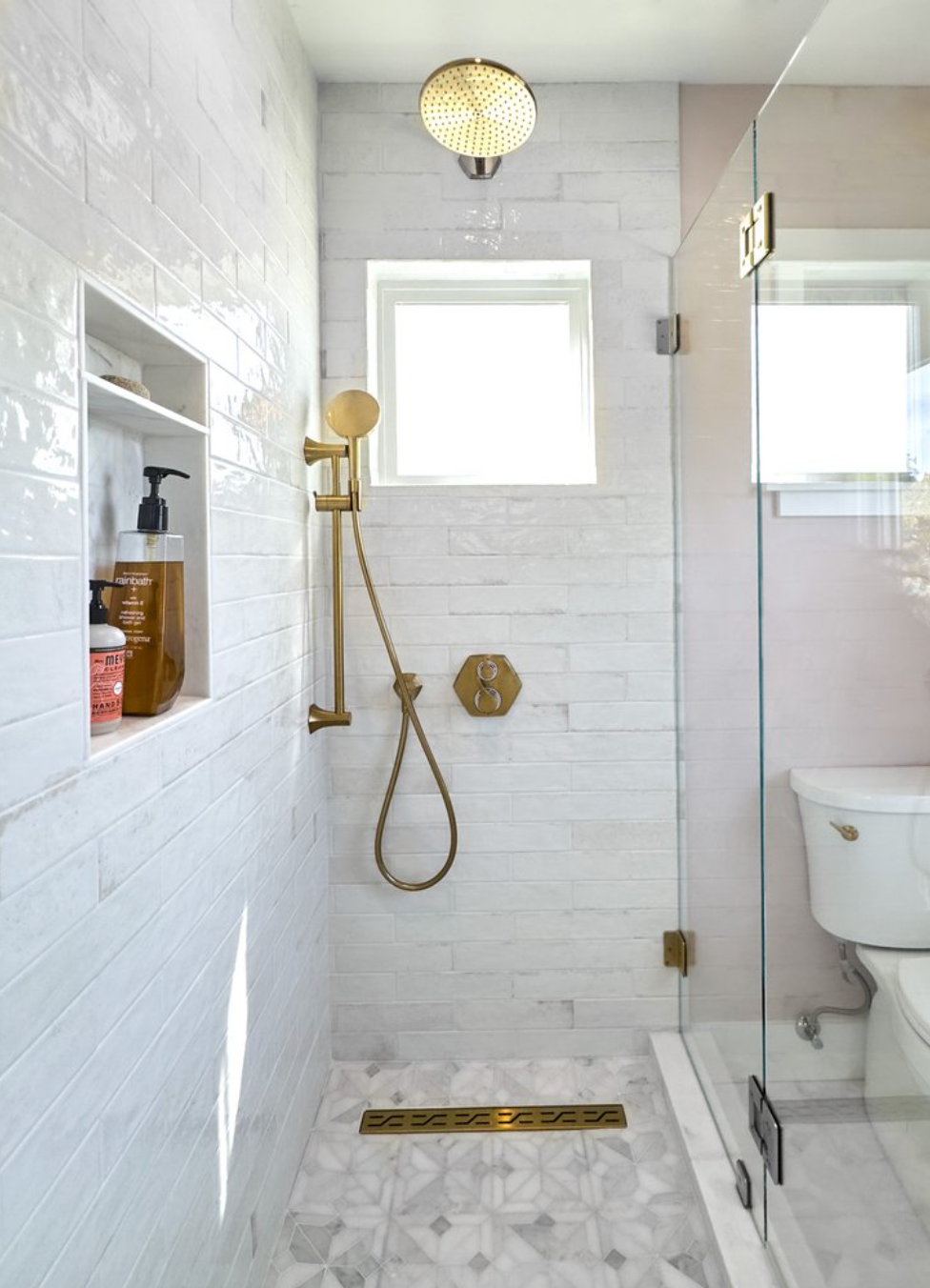 Teal tile bathroom with glass shower and soaking tub